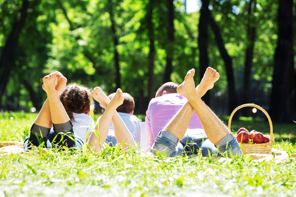 Happy family having weekend in summer park